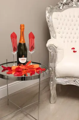 a glass table with a bottle of wine and two wine glasses at River Luxury Suites in Rome