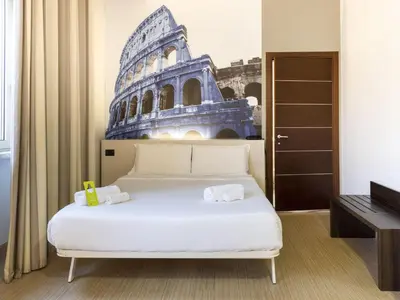 a bedroom with a bed with a picture of a building at B&B Hotel Roma Trastevere in Rome