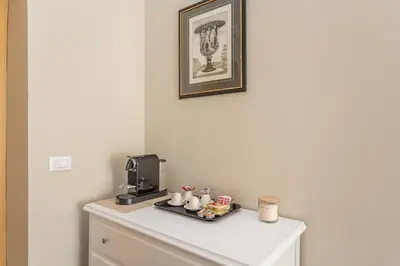 a table with a coffee maker and cups on it at Daplace - La Mongolfiera Rooms in Navona in Rome