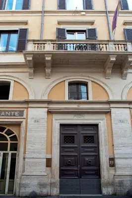 a building with two black doors and a balcony at Daplace - La Mongolfiera Rooms in Navona in Rome