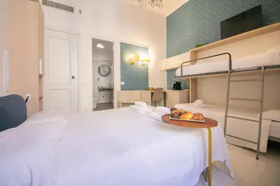 a bedroom with a bed with a tray of fruit on it at Caffe' e Cuscino in Rome