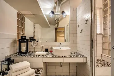 a bathroom with a sink and a mirror at Attic with Terrace by Trevi Fountain in Rome