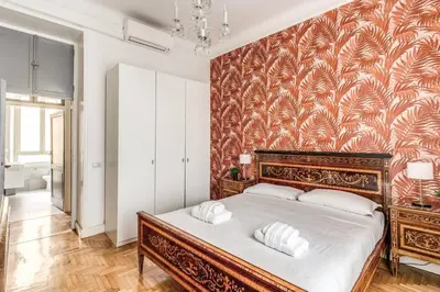 a bedroom with a large bed with a wall mural at Lovely renovated flat by Vatican in Rome