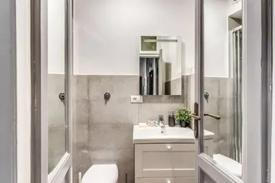 a bathroom with a toilet and a sink and a shower at Lovely renovated flat by Vatican in Rome