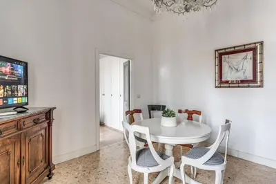 a white dining room with a white table and chairs at Lovely renovated flat by Vatican in Rome