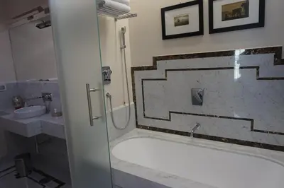 a bathroom with a shower and a tub and a sink at Trevi Palace Luxury Inn in Rome