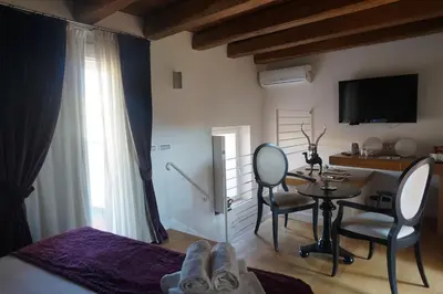 a bedroom with a desk and a table with chairs at Trevi Palace Luxury Inn in Rome