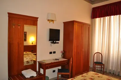 a room with a bedroom with a bed and a desk at Paramount in Rome