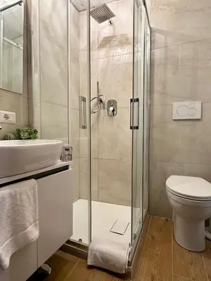a bathroom with a shower and a toilet and a sink at Leonina 75 Holidays in Rome