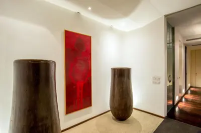 two vases sitting in a room with a painting at SK ROME Apartment Luxury Torre Argentina in Rome