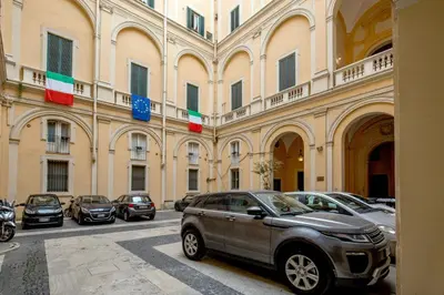 a group of cars parked in front of a building at SK ROME Apartment Luxury Torre Argentina in Rome