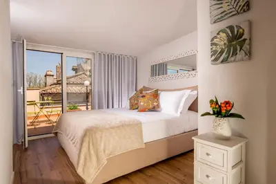 a bedroom with a bed and a large window at SK ROME - Apartment Luxury Navona in Rome
