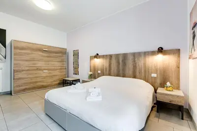 a bedroom with a large white bed in a room at B&B Casa Der Poeta in Rome