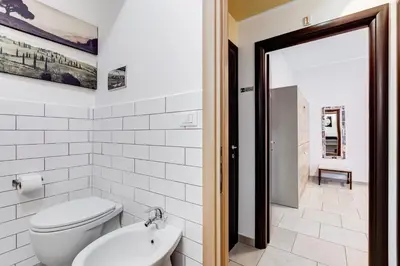 a white bathroom with a toilet and a sink at B&B Casa Der Poeta in Rome