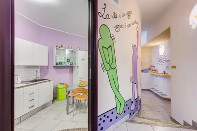 a kitchen with a wall with a person painted on it at B&B Casa Der Poeta in Rome