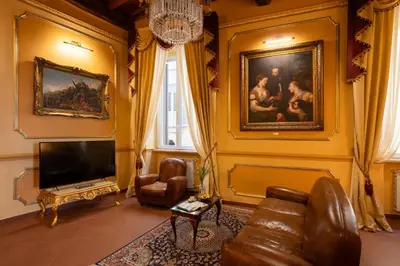a living room with a couch and a tv and a painting at Antica dimora navona in Rome