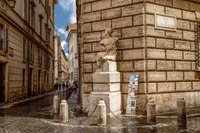 a statue sitting on the side of a building at Antica dimora navona in Rome