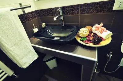 a bathroom with a plate of food on a sink at B&B Destinazione Roma in Rome