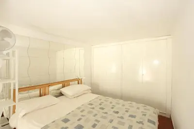 a bedroom with a bed with white walls at Penna Flats in Rome