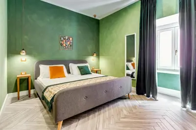 a bedroom with a bed with green walls at Ripetta Natural Suites in Rome