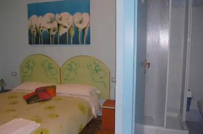 a bedroom with a bed with a picture of flowers at Casa Cleo in Rome
