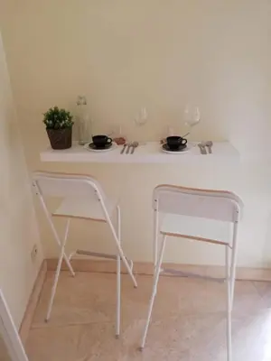 two chairs and a table with two glasses on it at Navona Private Rooms bnb in Rome
