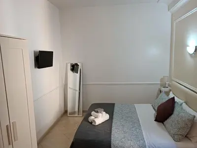 a small bedroom with a teddy bear laying on a bed at Navona Private Rooms bnb in Rome