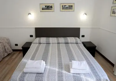 a bedroom with a large bed with two white pillows at GH Colosseum in Rome