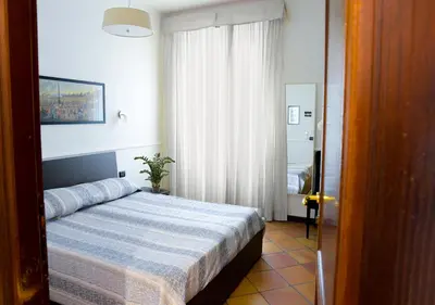 a bedroom with a bed with a blue comforter at GH Colosseum in Rome