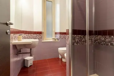 a bathroom with a toilet and a sink and a shower at Flowerome in Rome