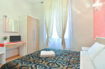 a bedroom with a bed with a window and a desk at Trani B&T Rooms in Rome