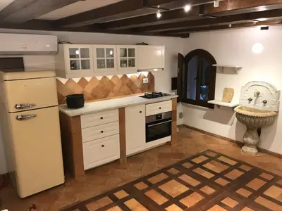 a kitchen with white cabinets and a sink at La Casa Dei Marmi in Rome