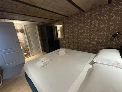 a bedroom with a large bed with towels on it at Giolitti Suite in Rome