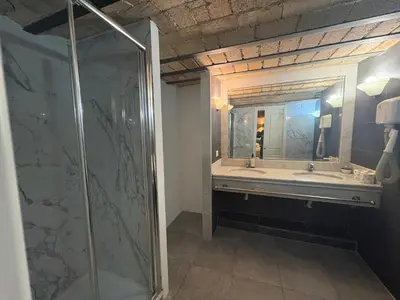 a bathroom with a shower and a sink and a mirror at Giolitti Suite in Rome