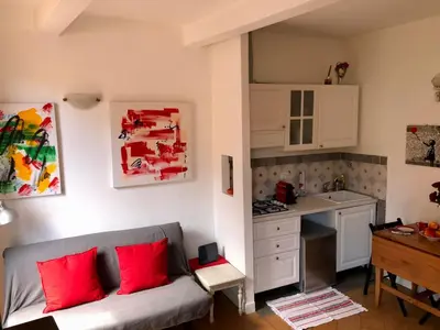 a living room with a couch and a kitchen at LeopardElla in Rome