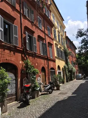 a red brick building with a scooter parked on a street at LeopardElla in Rome