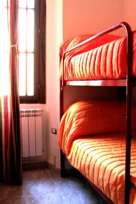a bedroom with a bunk bed and a window at MANDRUCHELLO'S in Rome