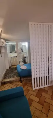 a room with a blue bed and a bathroom at Domus next Campo de'Fiori with thermal shower in Rome