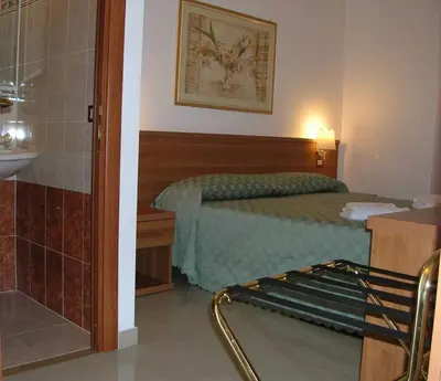 a hotel room with a bed and a bathroom at Emanuela Guest House in Rome