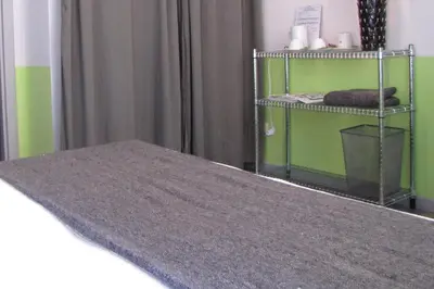 a bedroom with green walls and a bed with a gray rug at Trastevere Colors in Rome