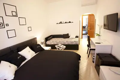 a bedroom with a black bed and a mirror at Il Mondo Di Amelia in Rome