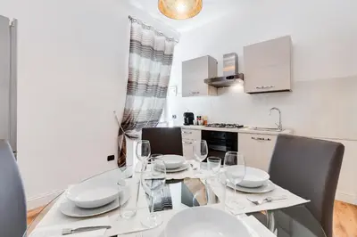a kitchen with a table with wine glasses on it at Vaticano Private Apartment in Rome