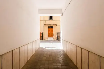 an empty hallway with a orange door in a building at Vaticano Private Apartment in Rome
