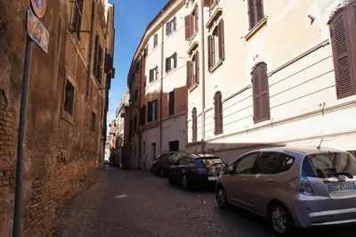 a small alley with cars parked next to buildings at Il Mio Giardino in Rome