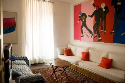 a living room with a couch and a painting on the wall at Il Mio Giardino in Rome