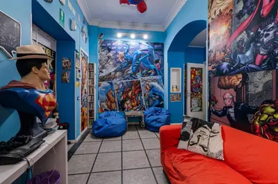 a superhero themed room with a red couch at Comics Guesthouse Hostel in Rome