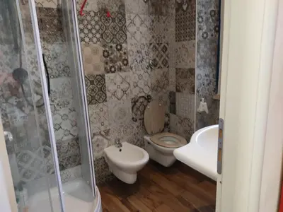 a bathroom with a toilet and a sink and a shower at Comics Guesthouse Hostel in Rome