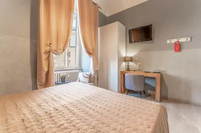 a bedroom with a blue bed with two candles on plates on it at Domus Domas & Boutique - Golden Keys Collection in Rome