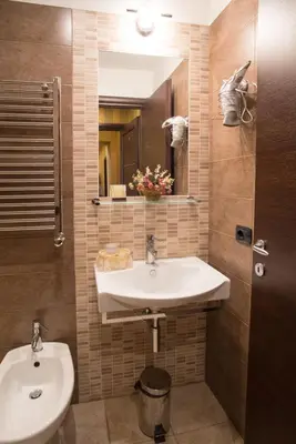 a bathroom with a sink and a mirror at Domus RomAntica in Rome