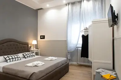 a bedroom with a bed with two towels on it at Domus St. John in Rome